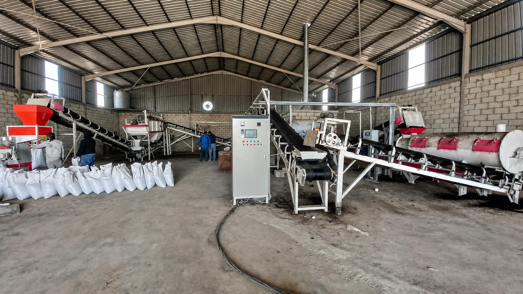 Organic fertilizer production facility with conveyors and control panel